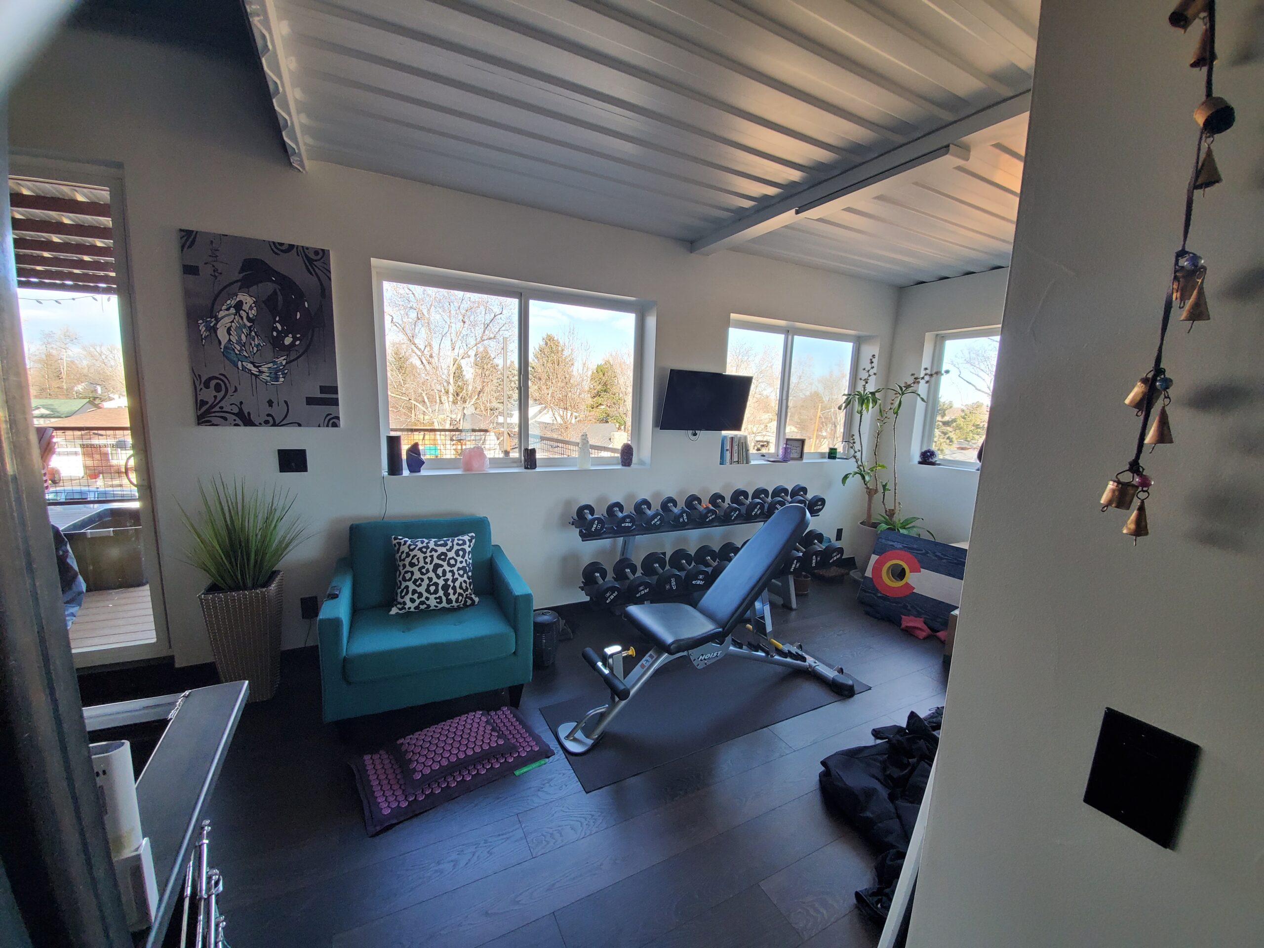 A finished lounge with seating and large windows.