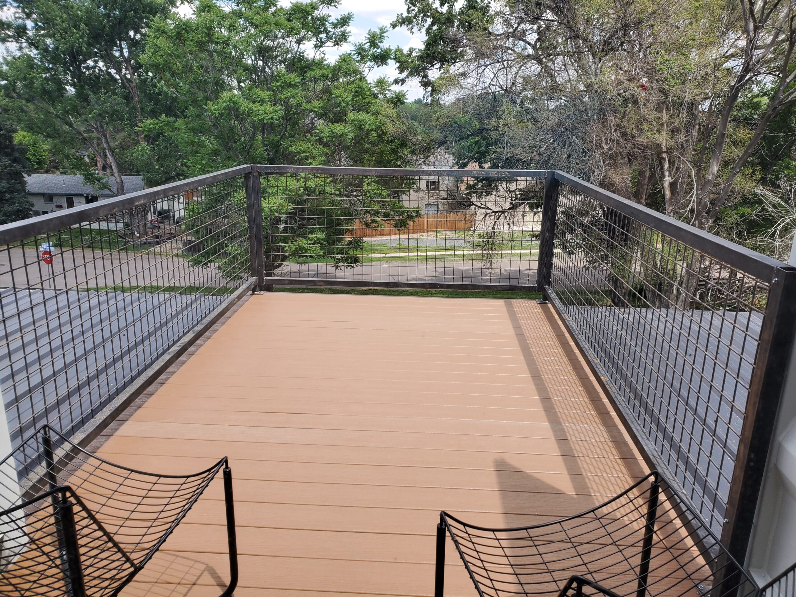 A rooftop deck with steel cable railings.