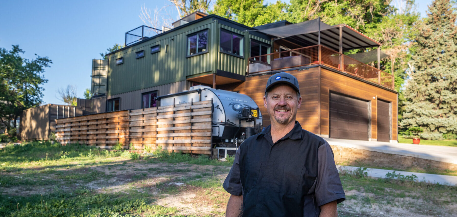 Shane standing outside a completed multi-story Carbon Dwell.