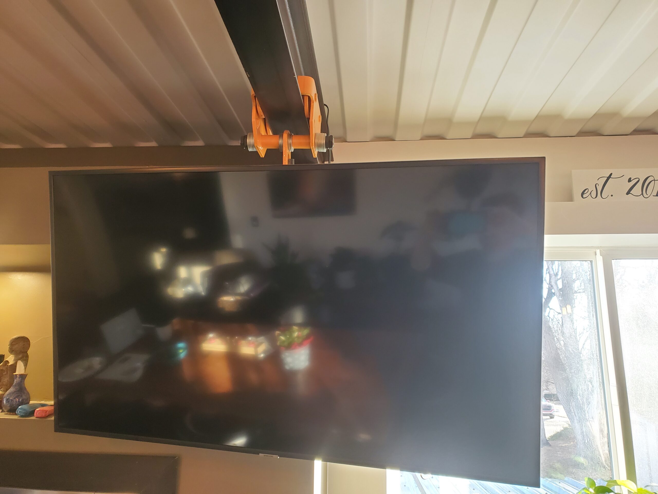 A television being positioned with a ceiling-mounted lift.